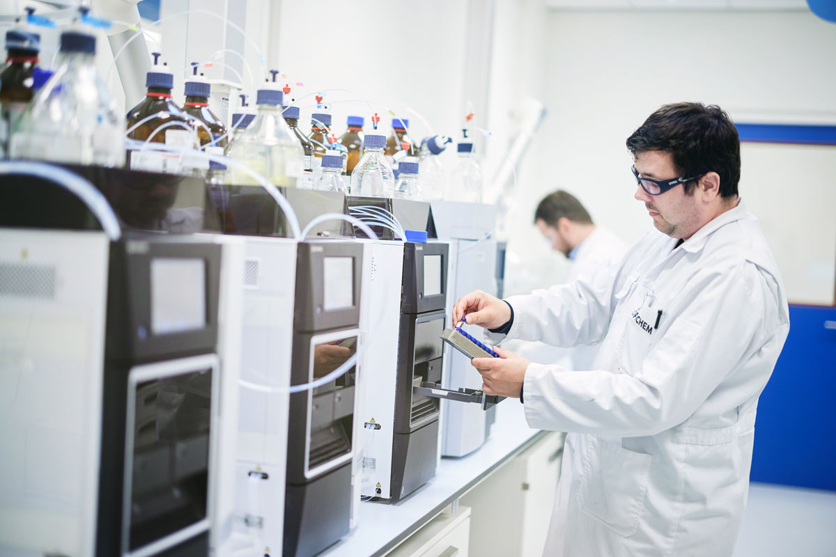 Man conducting quality assurance and GMP compliance at Ofichem CDMO.